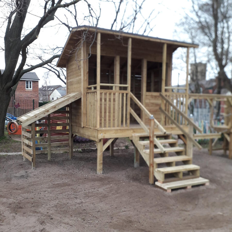 The play house has a storage area, balcony, slide and clibing wall